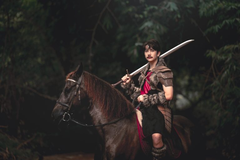 A heroic warrior on horseback, cloaked in medieval armor, evokes transformation and courage amidst a lush, mysterious forest. A visual metaphor for timeless story arcs.