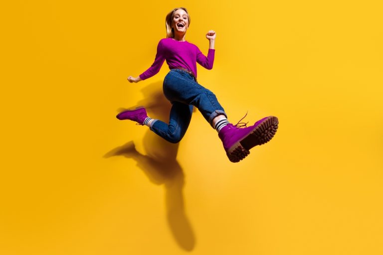 A whimsical image of a woman making the fool's leap of faith, embodying the untamed energy of The Fool's Journey in brand storytelling.